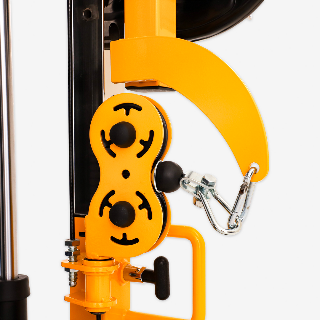 Close-up of a yellow mechanical device with black accents on a white background