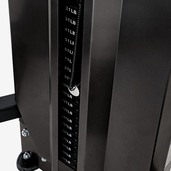 Close-up of a weight machine with weight adjustment dial on a white background