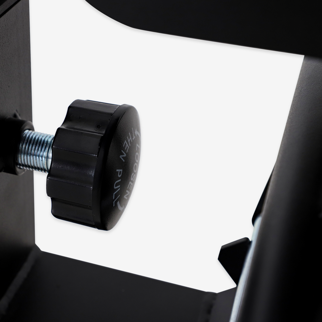 Close-up of a black knob on a mechanical device with a white background