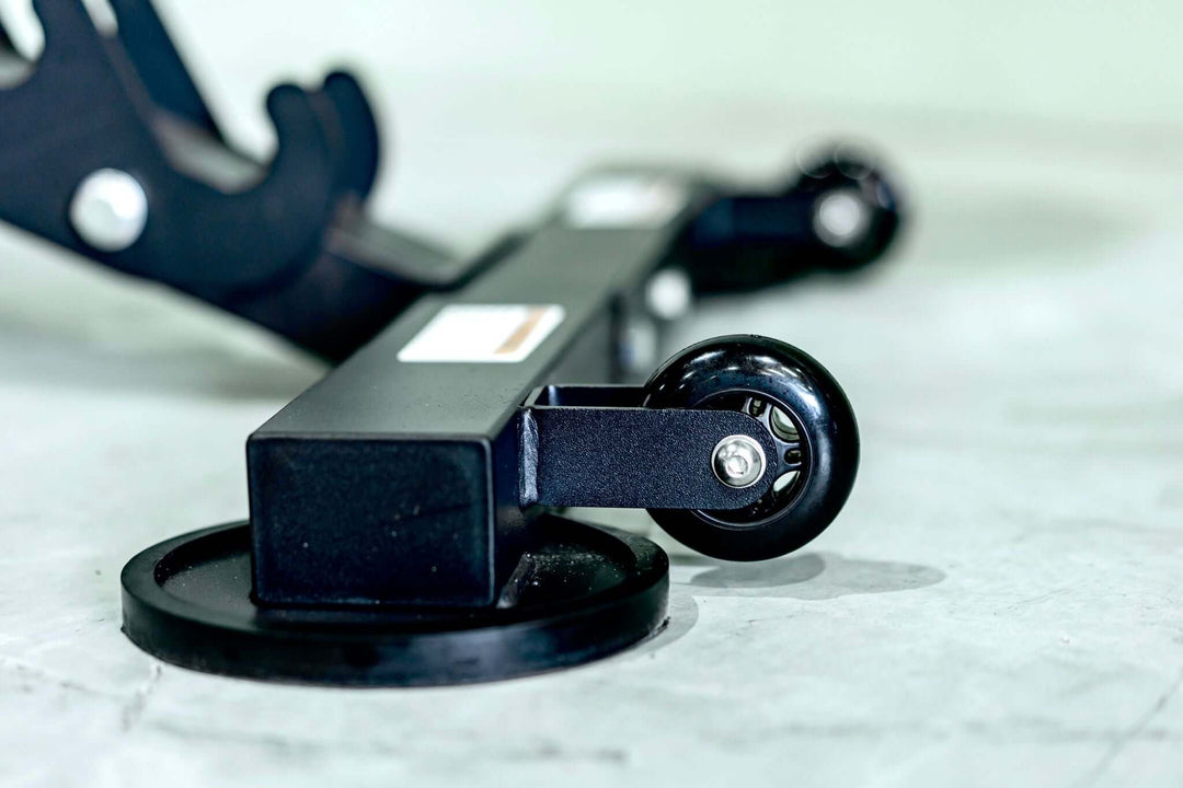 Close-up of the adjustable bench XRAB02 wheel, showcasing its sturdy construction and mobility features.