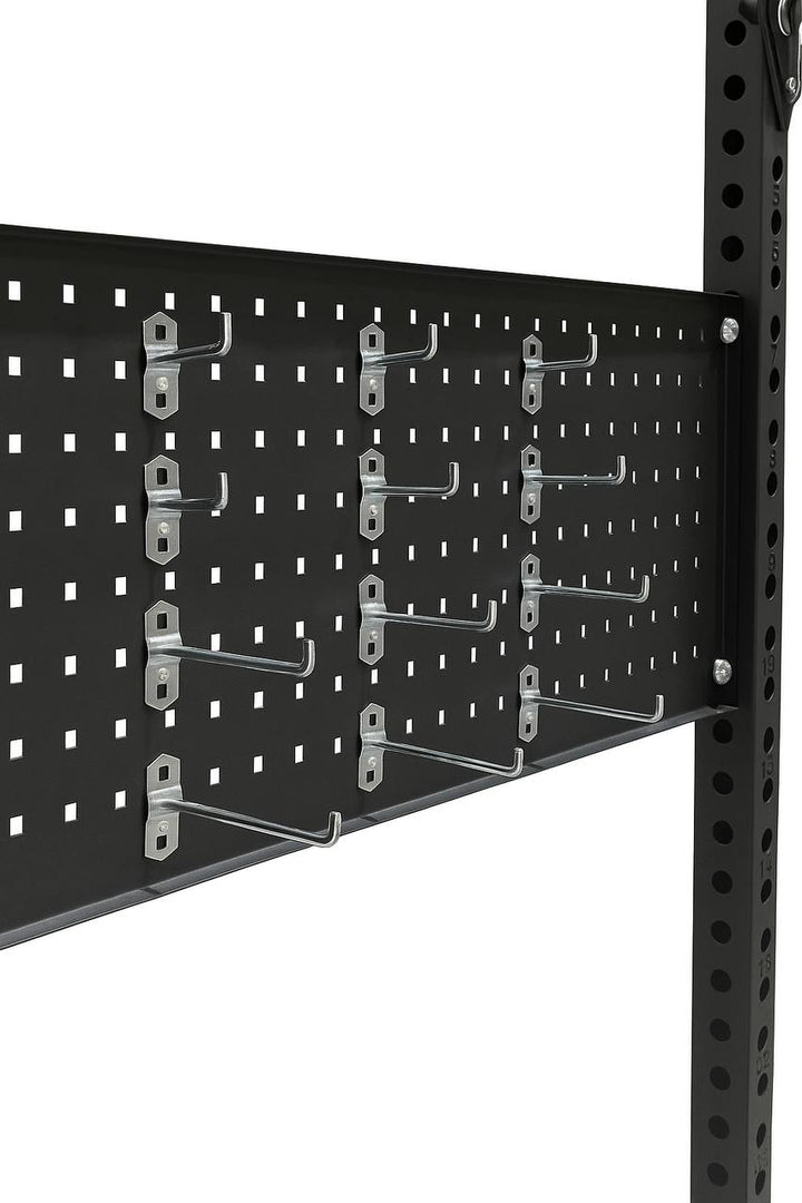 Close-up of black pegboard with metal hooks for organizing gym equipment and accessories.