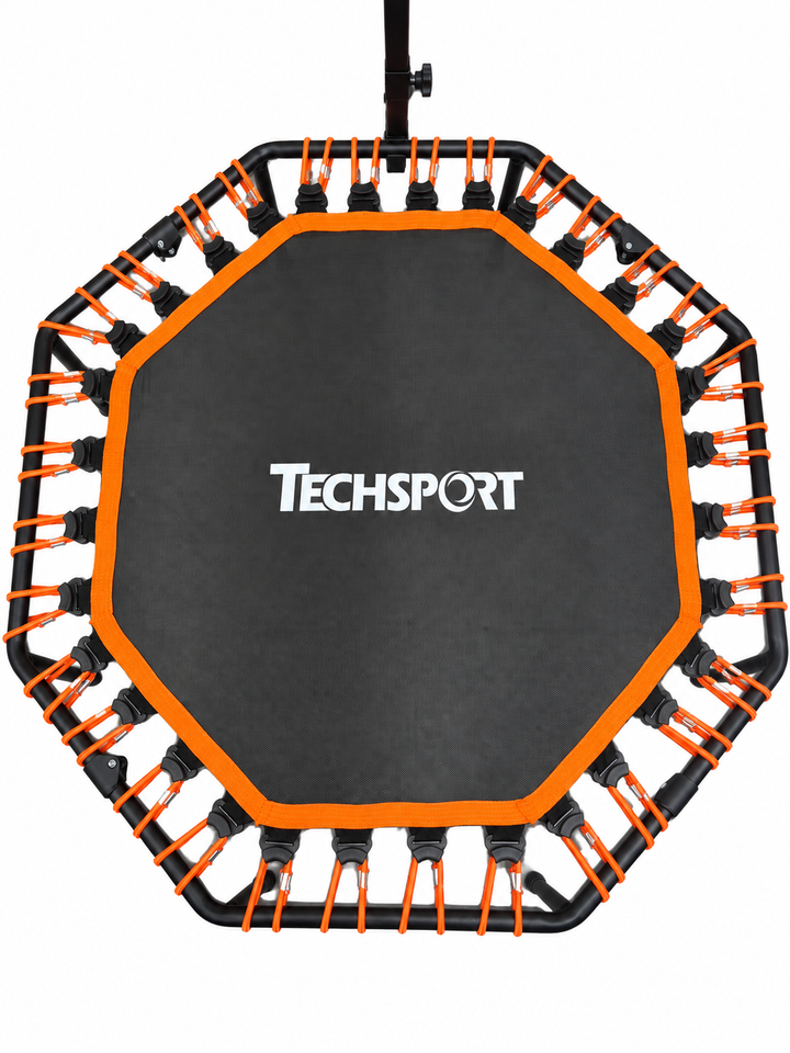 TECHSPORT trampoline - overhead detail of orange bungees and branded mat