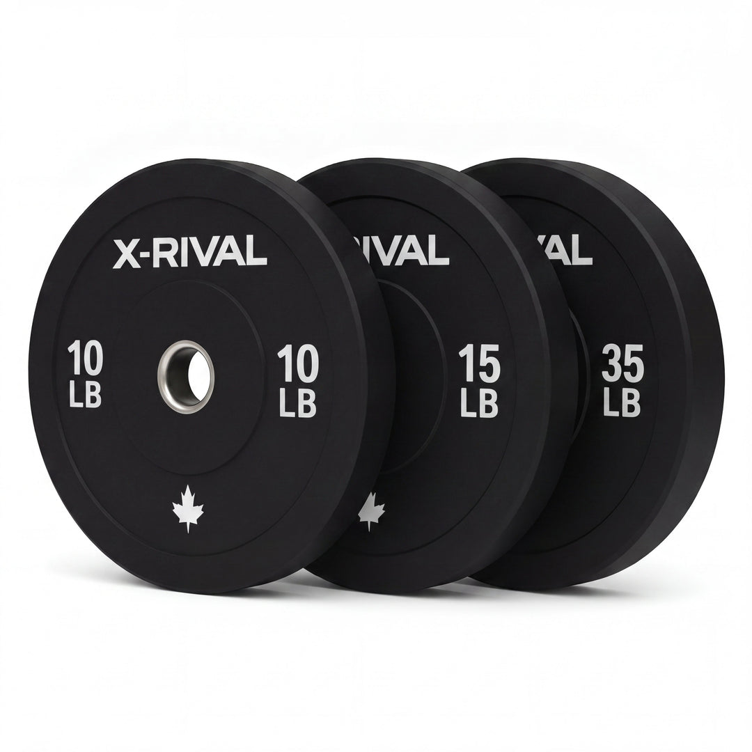 Set of X-Rival bumper plates in black with weight labels on a white background