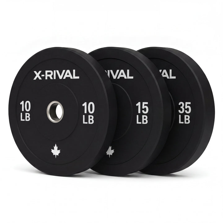 Set of X-Rival bumper plates in black with weight labels on a white background
